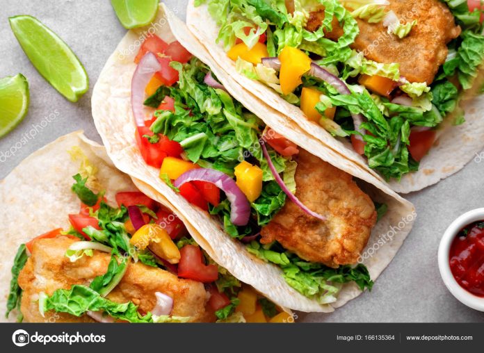 Delicious fish tacos on cooking sheet